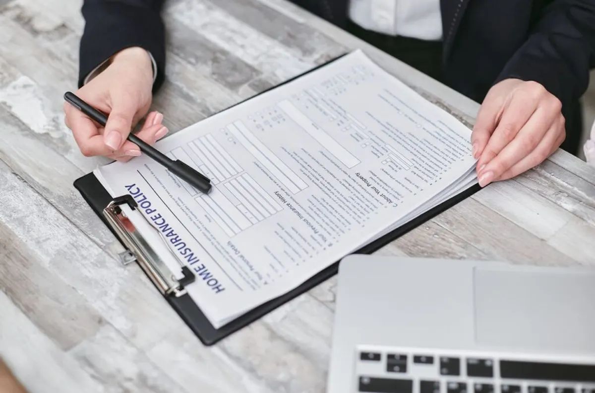 Reviewing commercial insurance claim documents at a desk